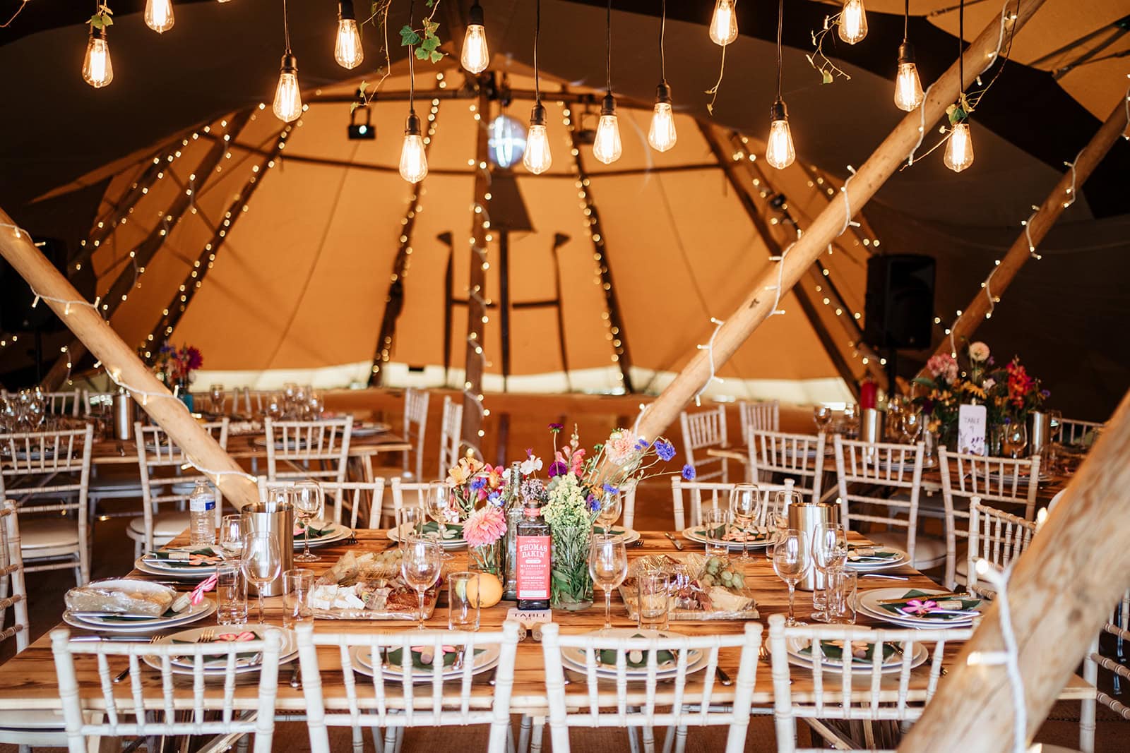 Rustic wedding reception in cozy decorated tent