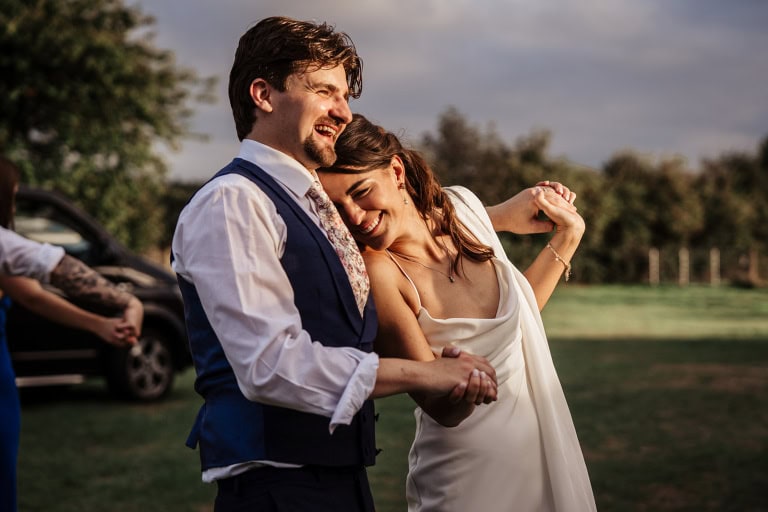 Happy couple dancing at outdoor wedding reception