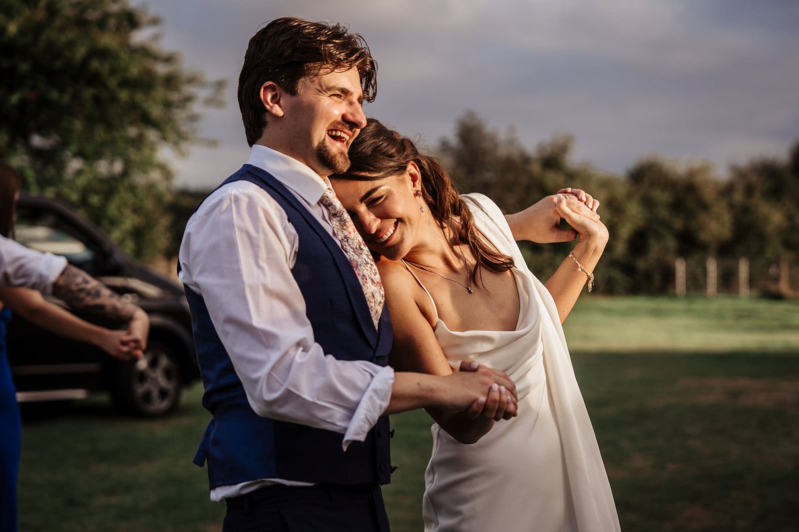 Happy couple dancing at outdoor wedding reception