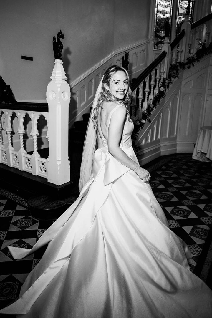 Bride in wedding dress smiling indoors at The Elvetham.
